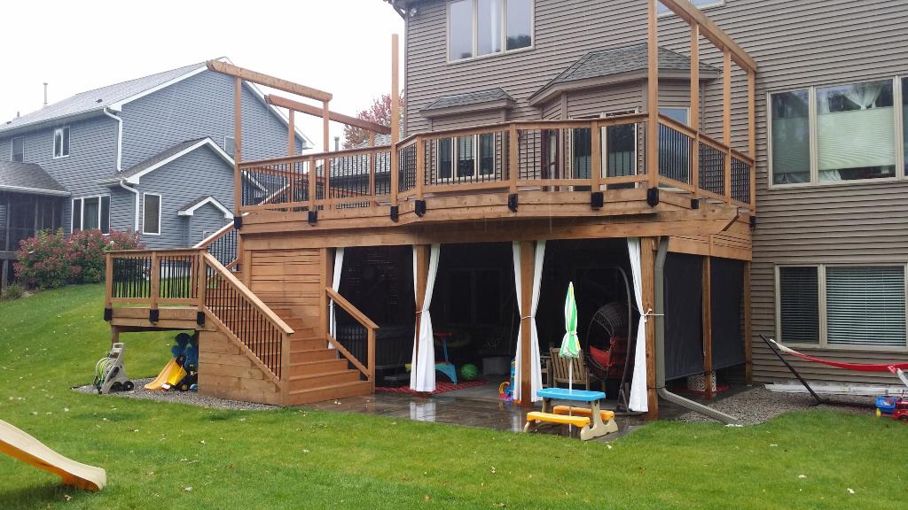New deck with privacy screen, brick pavers, hot tub and storage