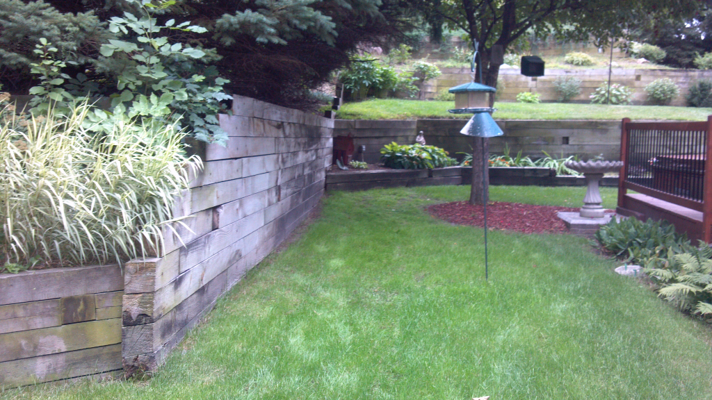 Backyard renovation landscaping with brick retaining wall