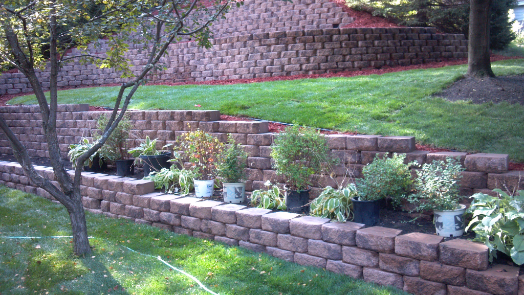 Backyard renovation landscaping with brick retaining wall