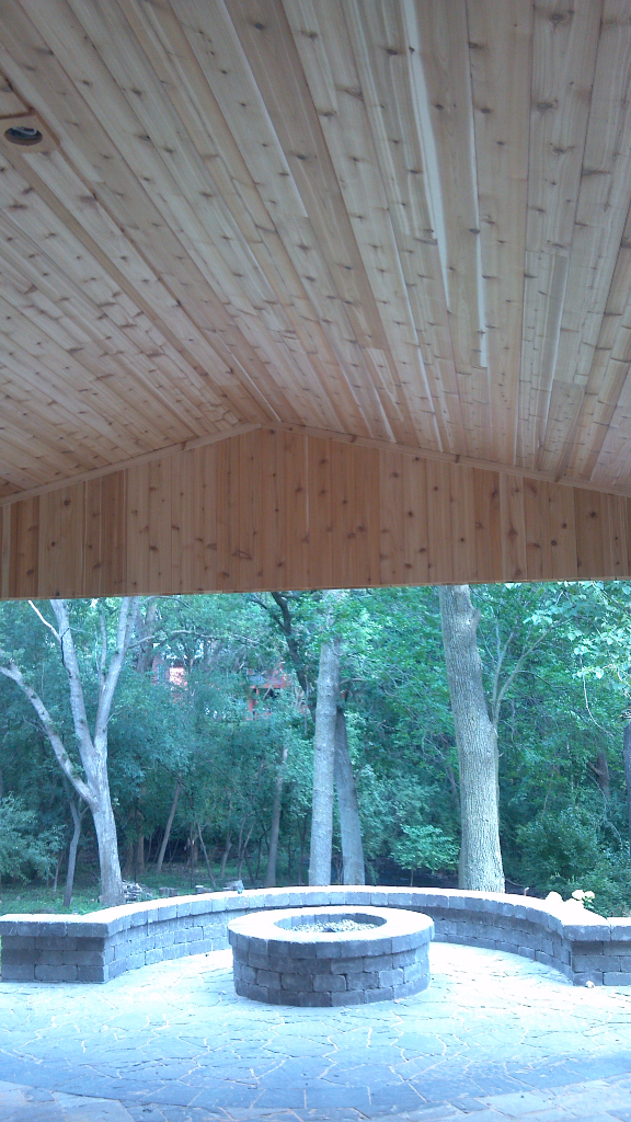 Inside Cedar Arbor and fire pit with seat wall